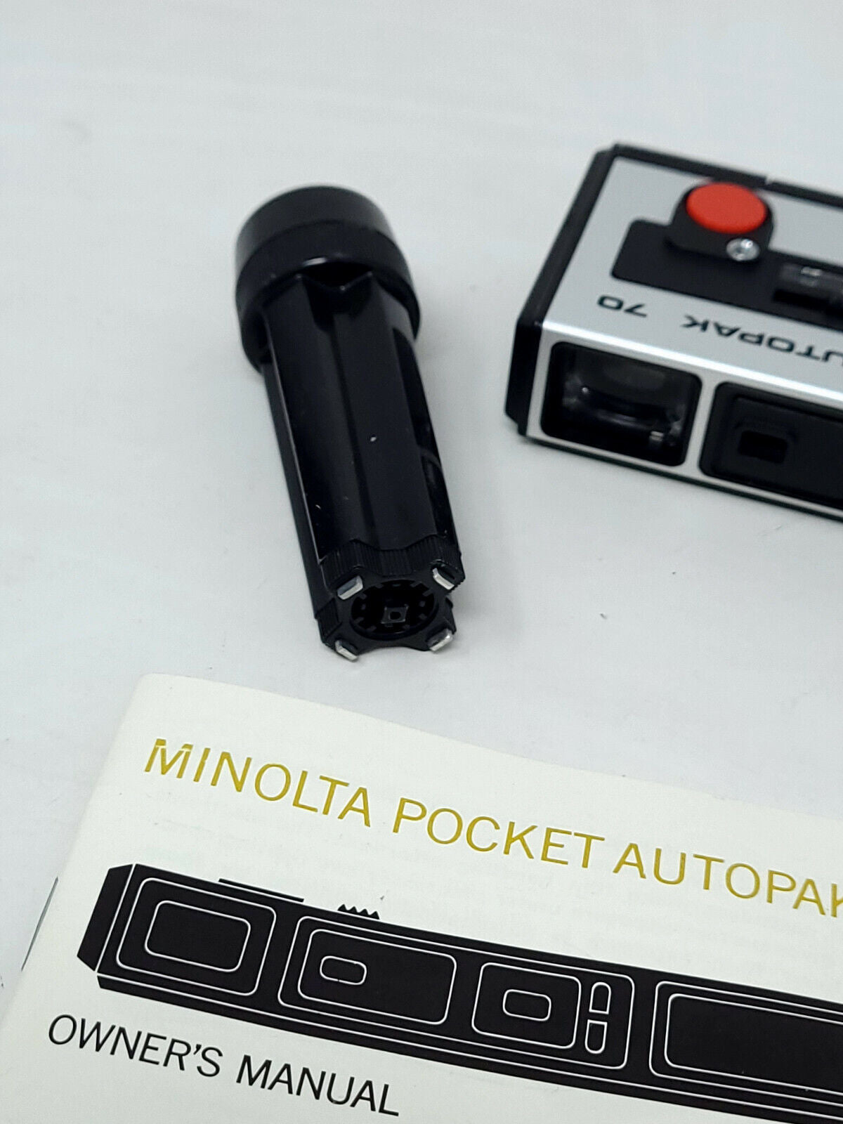 Vintage Minolta pocket autopak 70 - with flash cubes, stand, and manual